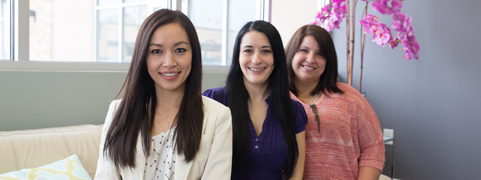 Dr. Tran and two team members smiling together