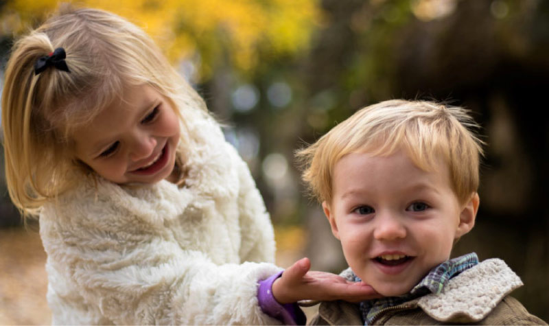 older sister shows off her brother's new dental sealants