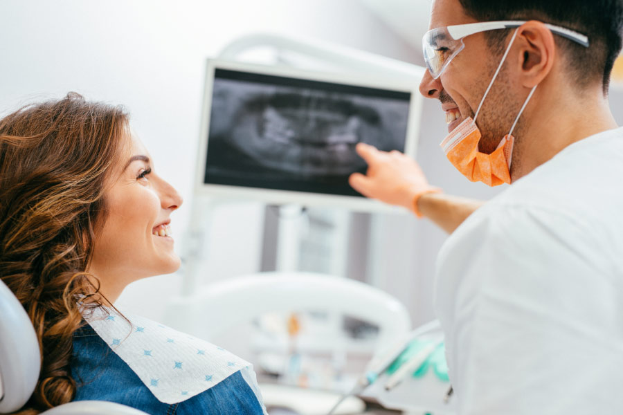 dentist explaining a dental x-ray to a female patient