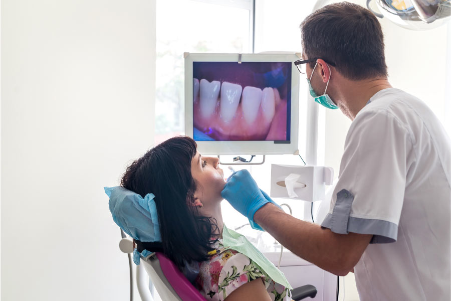 female patient in the dentist chair undergoing teeth binding