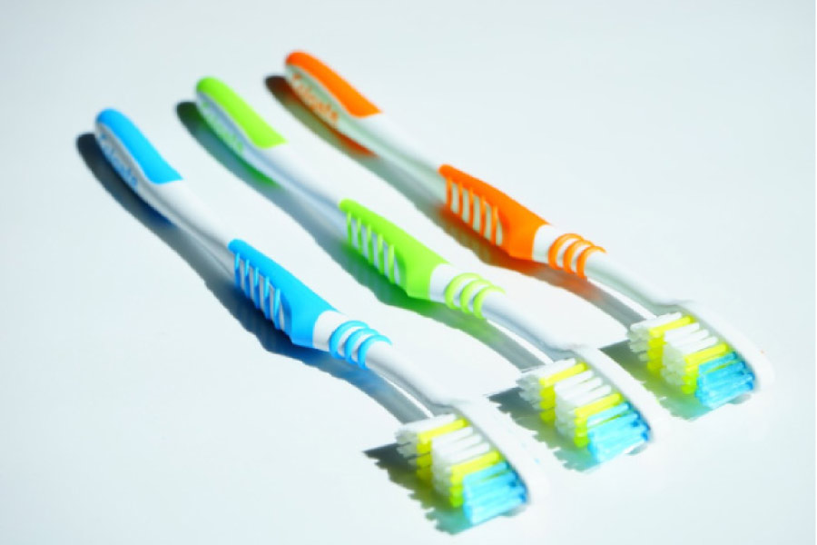 three toothbrushes side by side