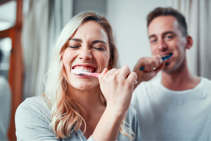 couple brushing their teeth together